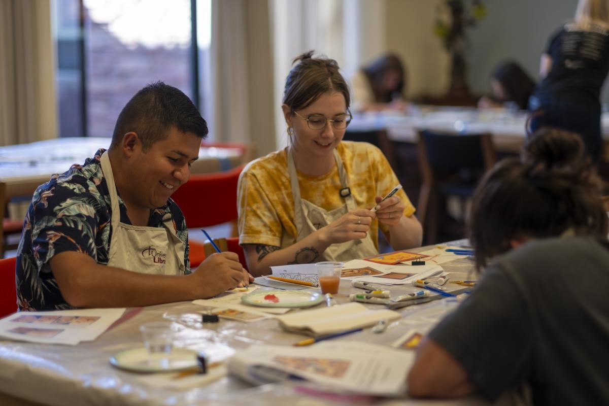 campus community members work on a craft in the library