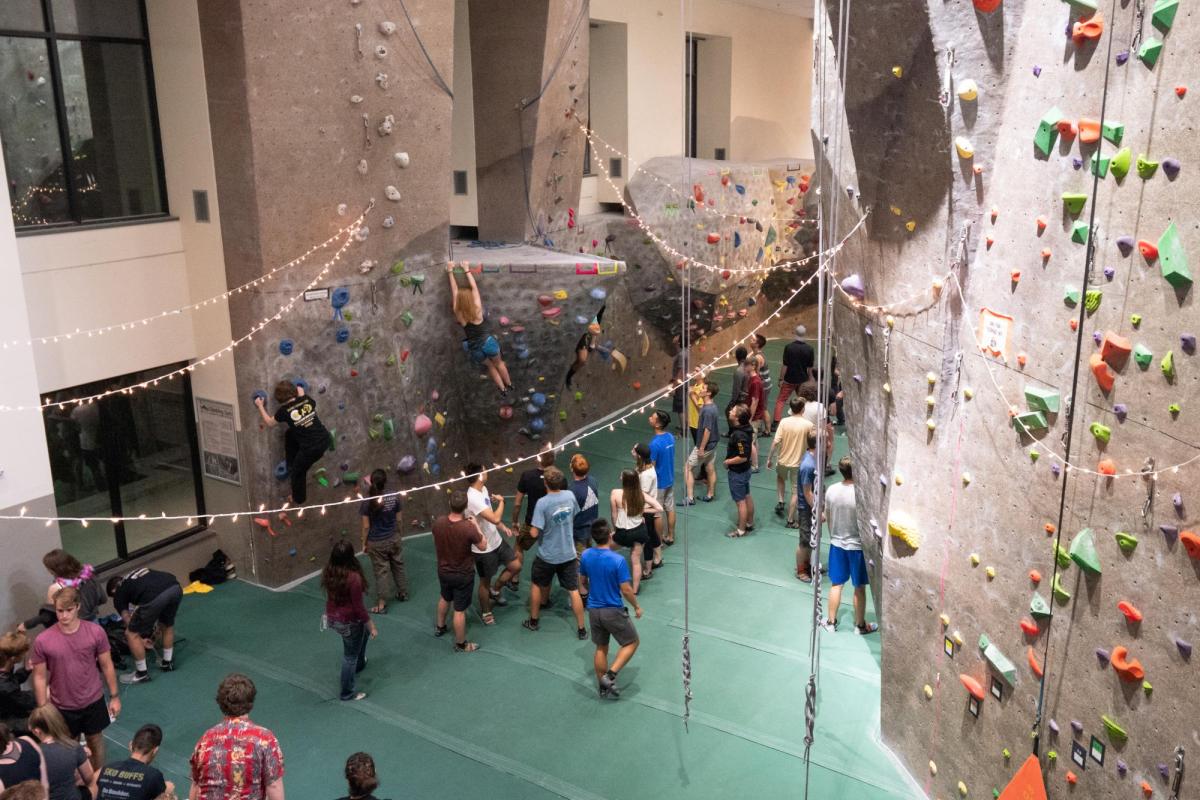 Students hang out by the climbing wall during Connect at The Rec