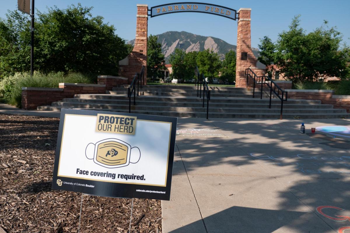 A Protect Our Herd–face covering required sign at the entrance of Farrand Field
