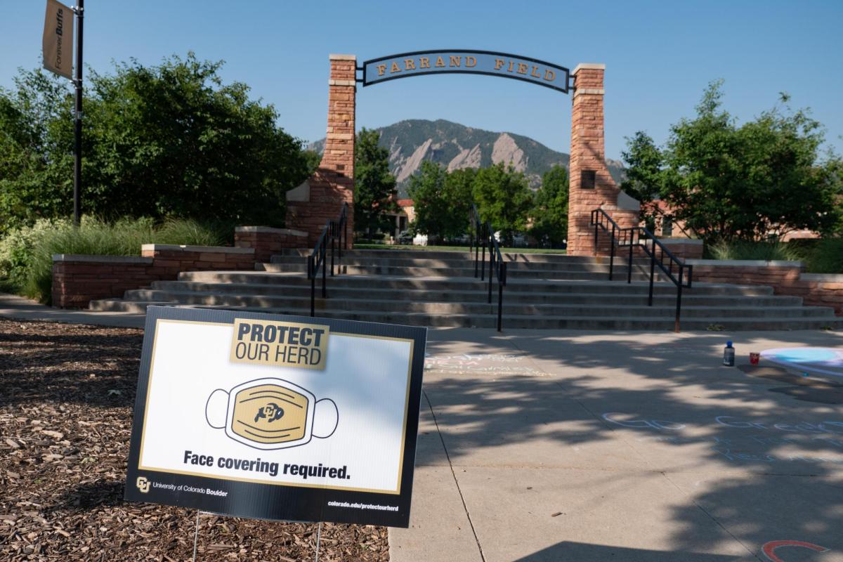 A Protect Our Herd–face covering required sign at the entrance of Farrand Field