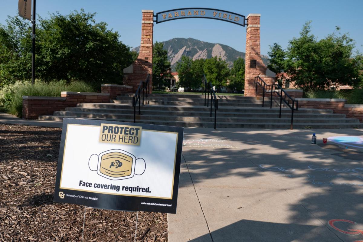 A Protect Our Herd–face covering required sign at the entrance of Farrand Field