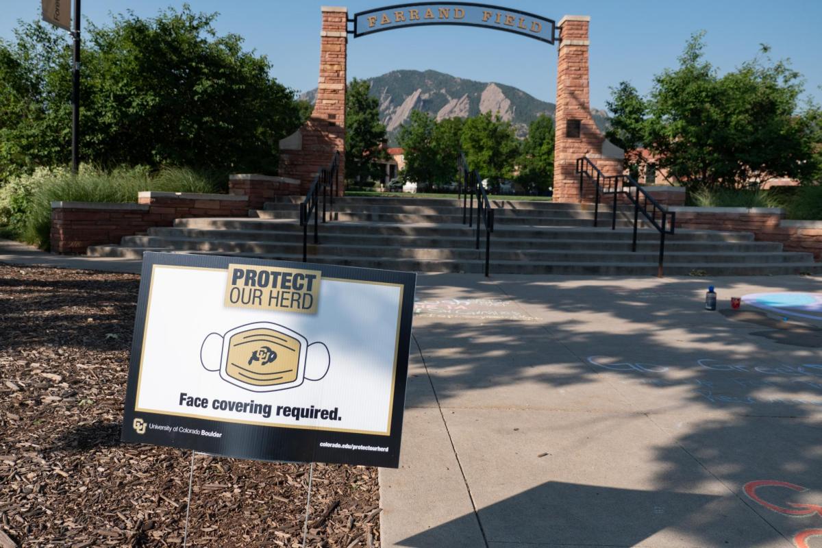 A Protect Our Herd–face covering required sign at the entrance of Farrand Field
