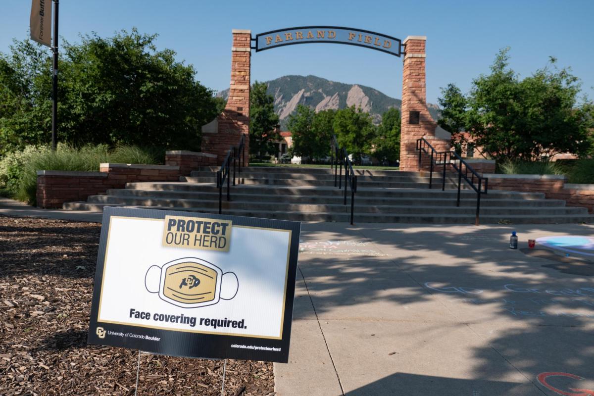 A Protect Our Herd–face covering required sign at the entrance of Farrand Field