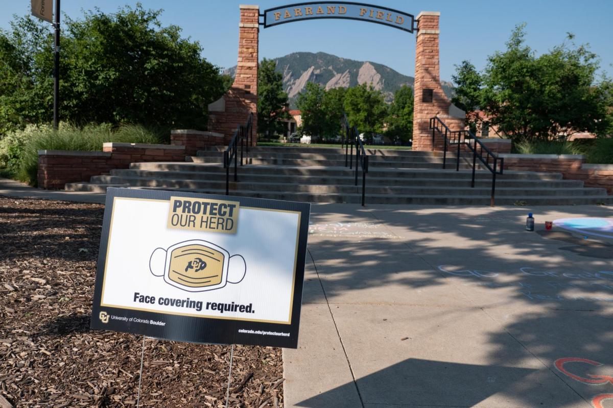 A Protect Our Herd–face covering required sign at the entrance of Farrand Field