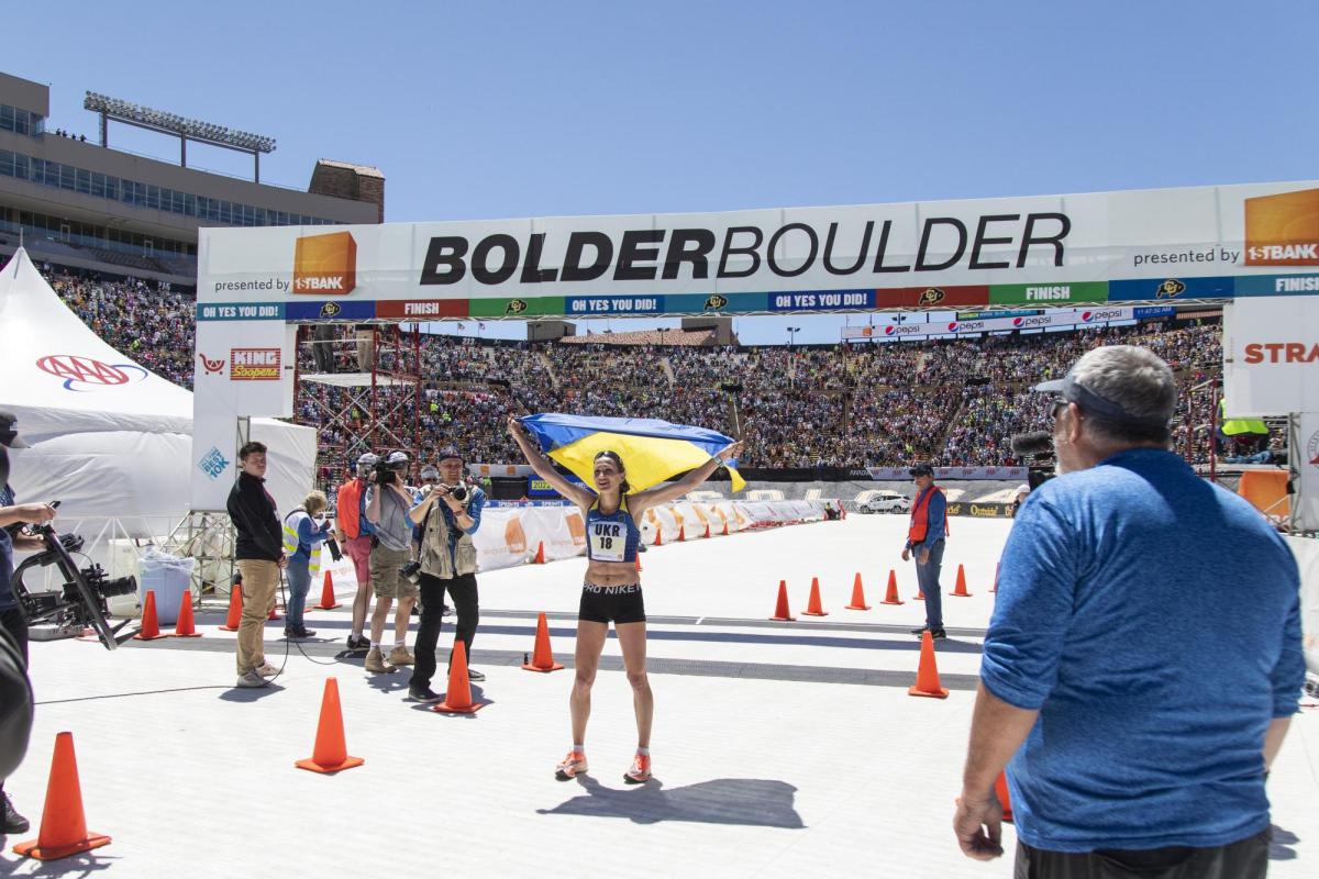 Participant celebrates end of race at Folsom Field