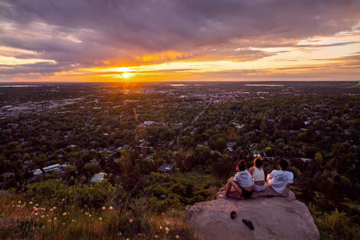 CU Boulder students watch sunset from Flagstaff Mountain
