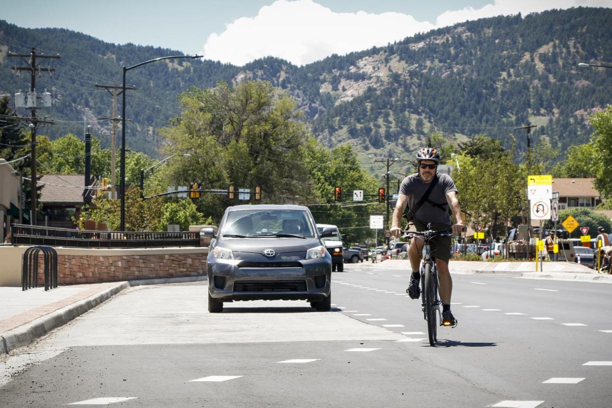 Aaron Johnson rides bicycle on road with motorists