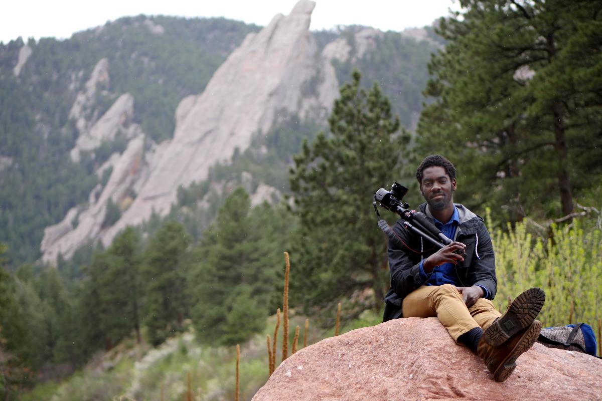 Ani Yahzid with his camera outdoors
