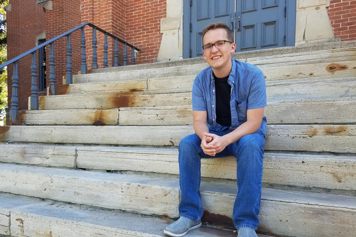 Austin Braun on the steps of Old Main