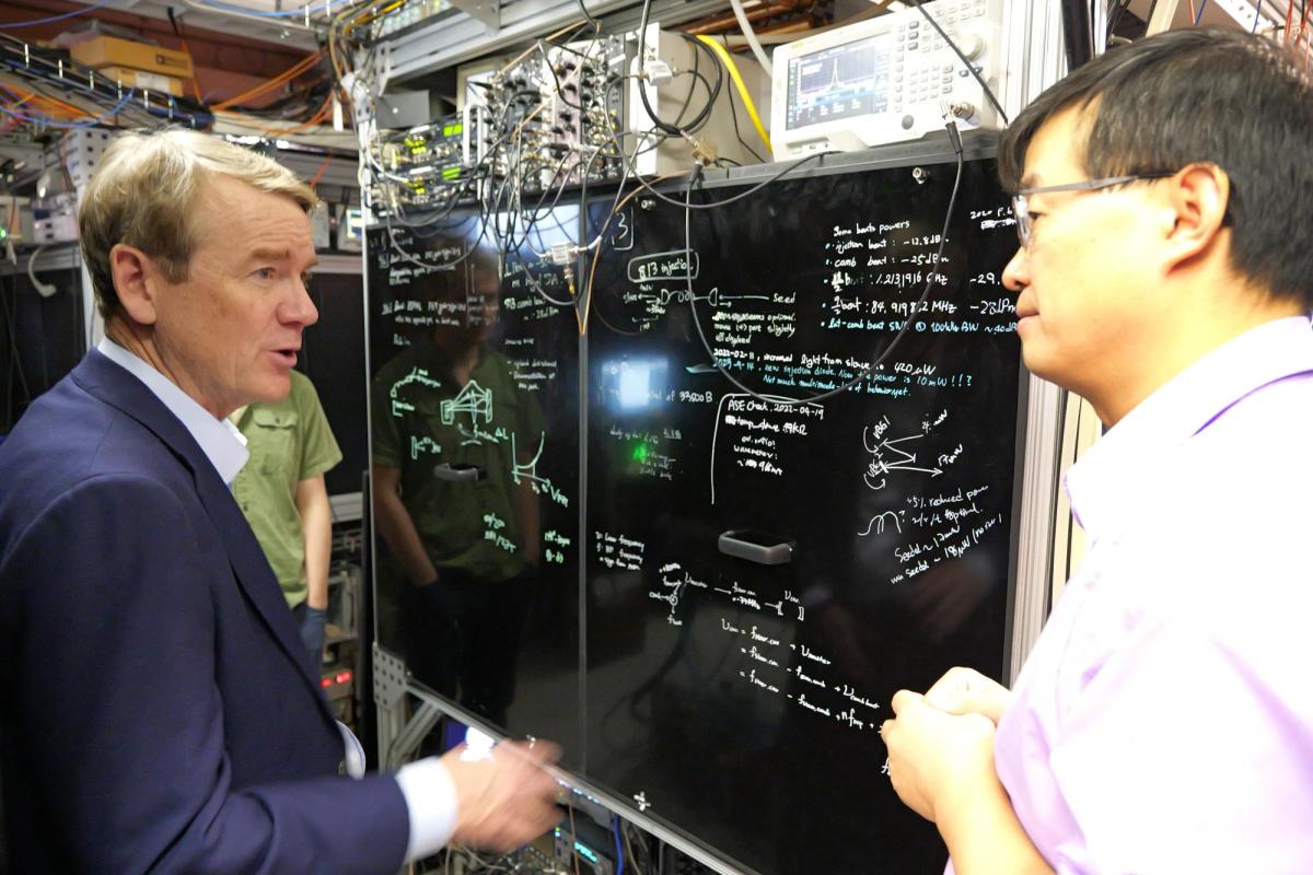 Sen. Michael Bennet visits with Jun Ye, professor adjoint and fellow, while visiting JILA