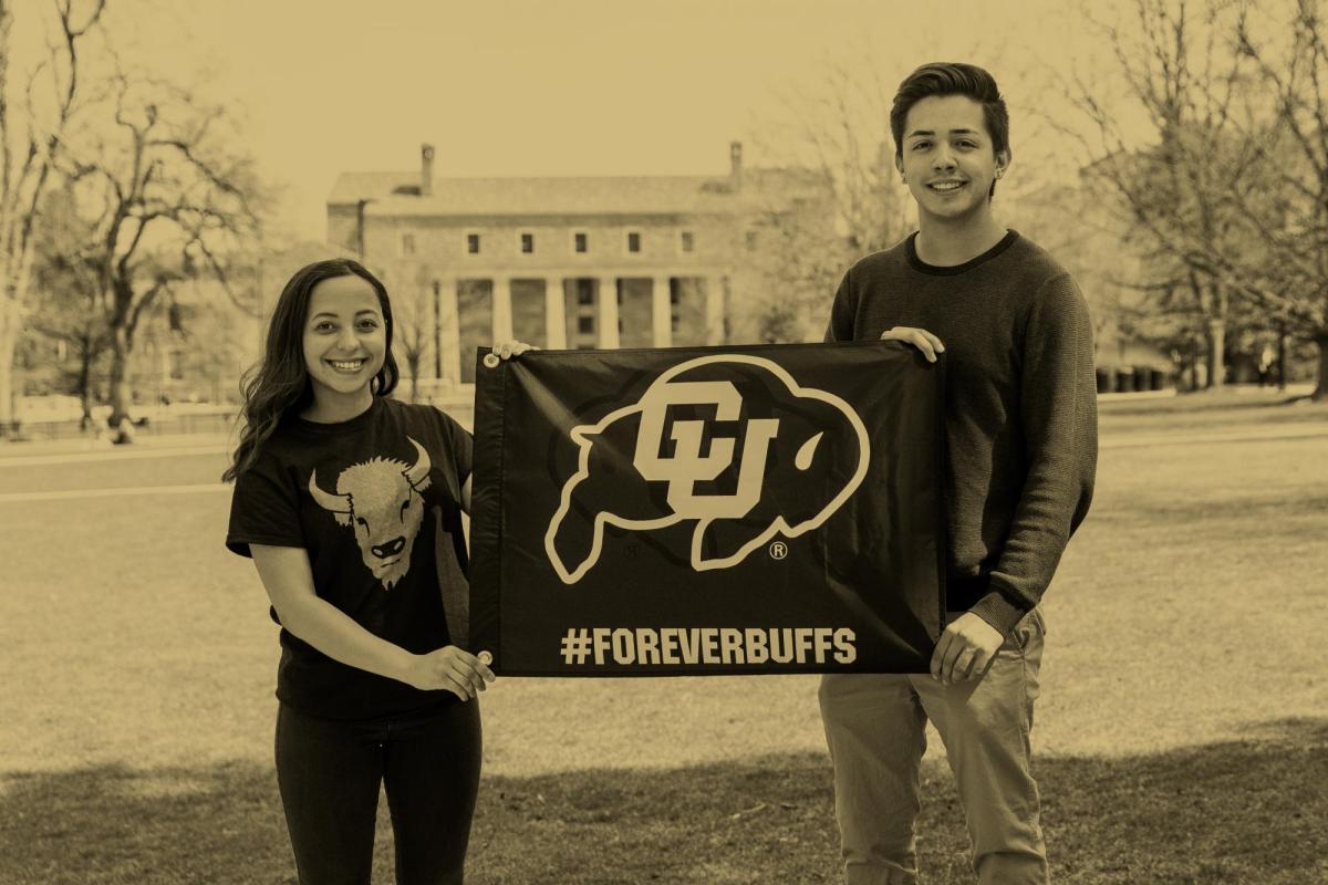 Students holding a Forever Buffs flag in front of Norlin
