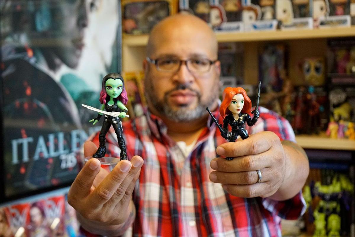 Christopher Bell poses with Gamora and Black Widow action figures