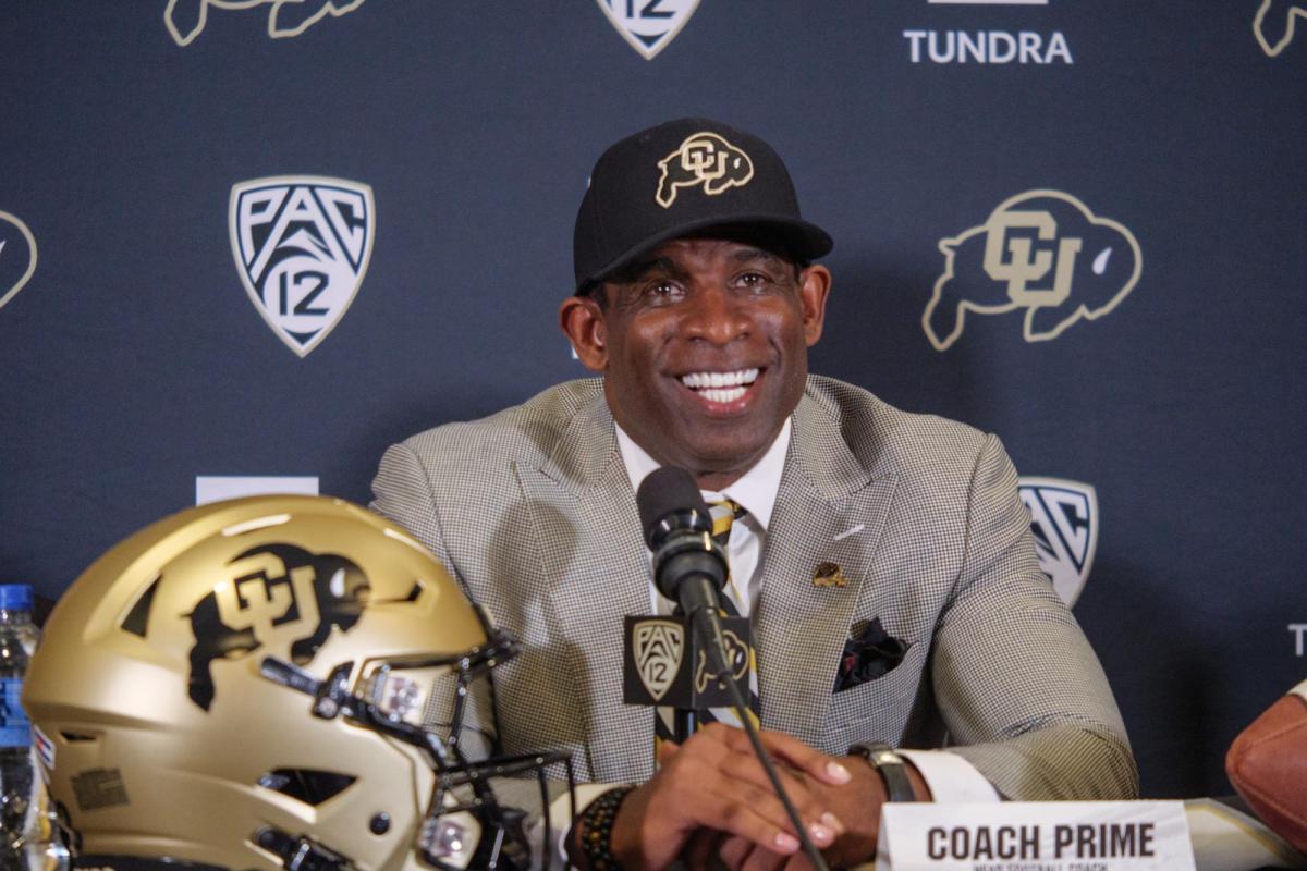 Deion Sanders (Coach Prime), smiles during a humorous moment during the press conference announcing his hiring as University of Colorado football teamÕs 28th head coach at the Touchdown Club at Folsom Field on December 4, 2022. (Photo by Glenn Asakawa/University of Colorado)