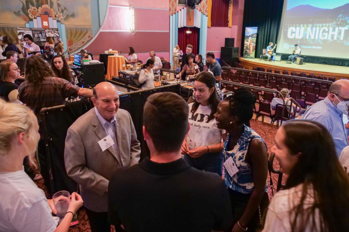 CU Boulder Chancellor Phil DiStefano, left, greets guests and students at the CU Night in Downtown Boulder event at Boulder Theater