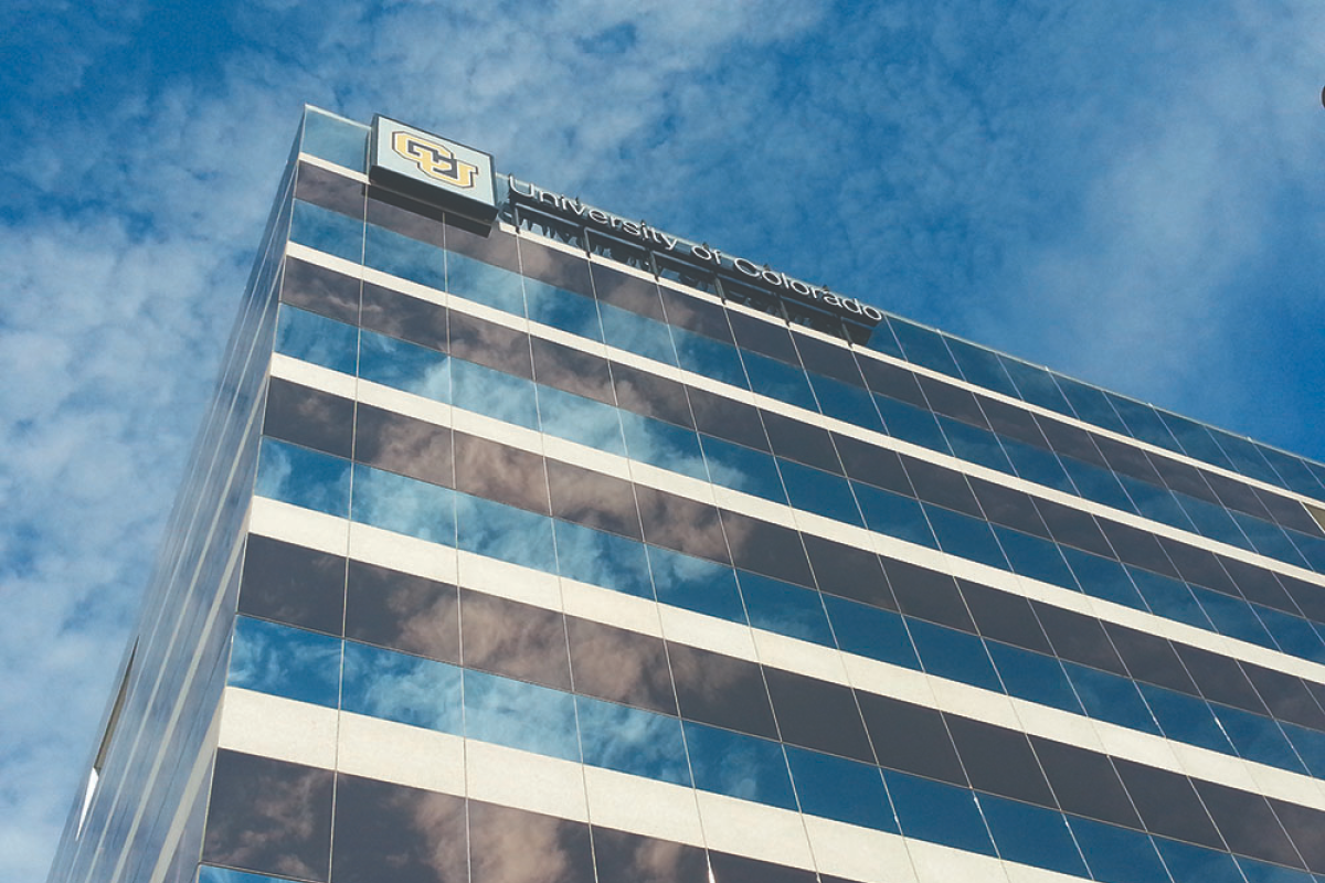 A CU building reflects clouds in the sky