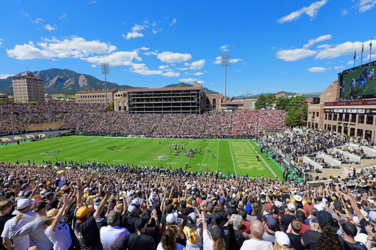 Fans cheering at CU football game at Folsom Field