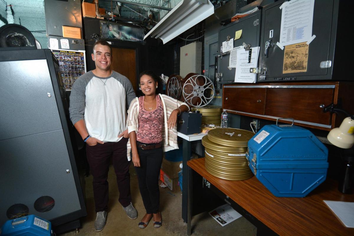 Students Adam Elbeck and Melina Dabney in Muenzinger Auditorium's projector room