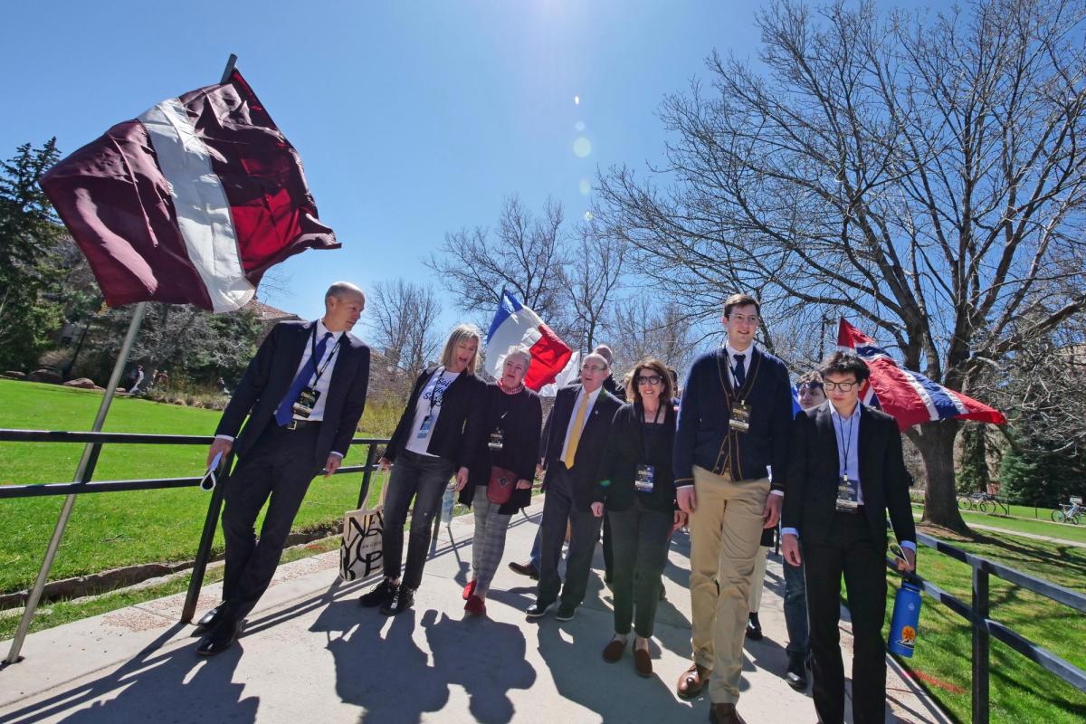 The 2022 Conference on World Affairs procession through international flags