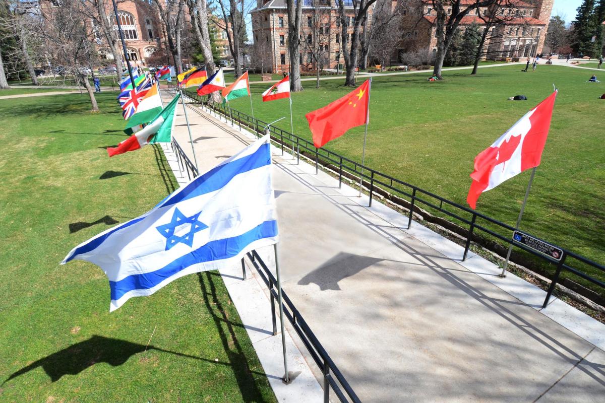 International flags lined up for the annual Conference on World Affairs at CU Boulder