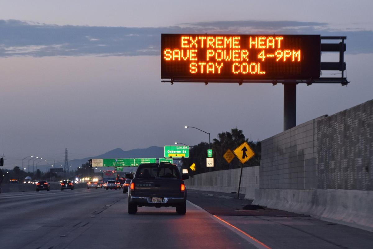 Highway road sign reads: "Extreme heat. Save power 4-9 p.m. Stay cool."