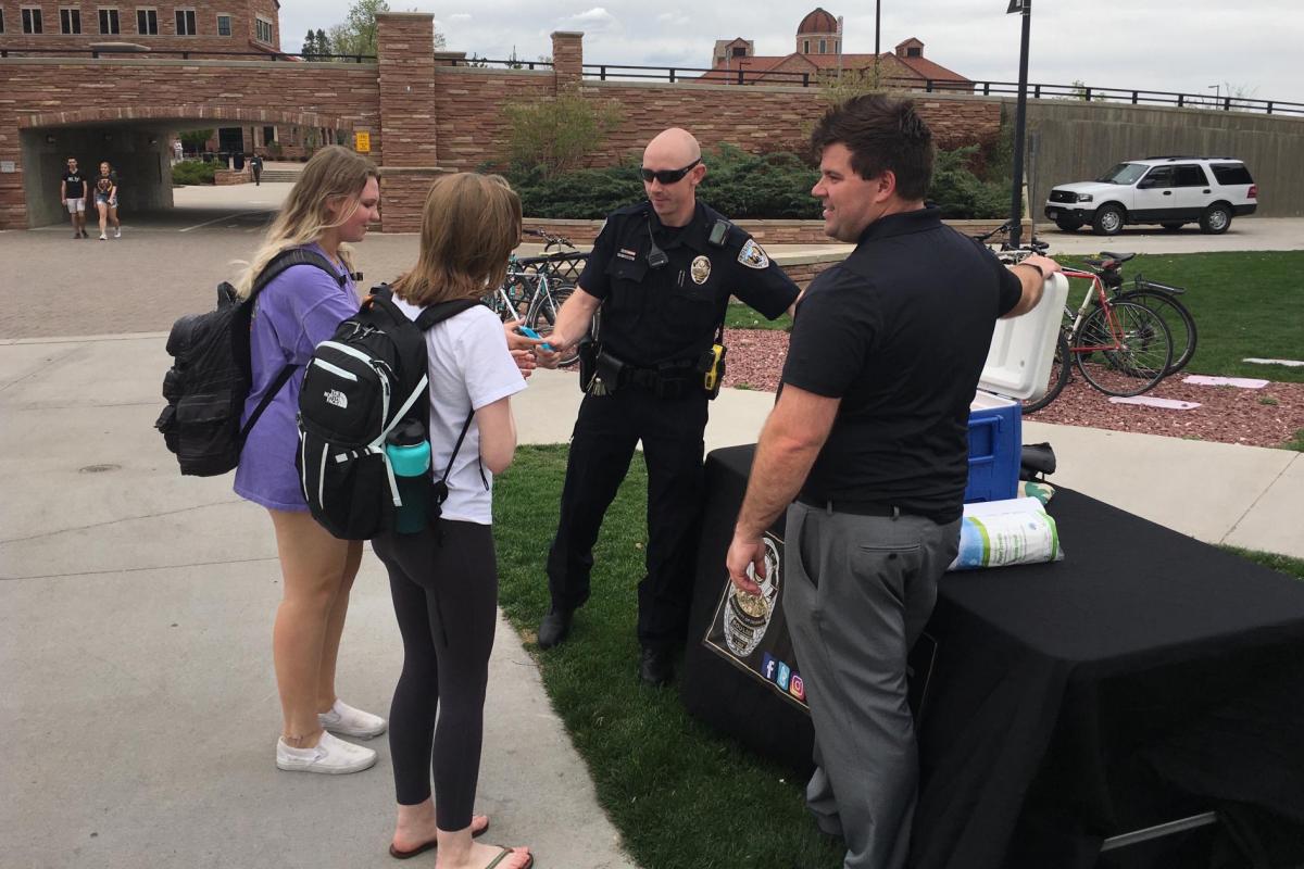 Folks take a break and have popsicles with cops.