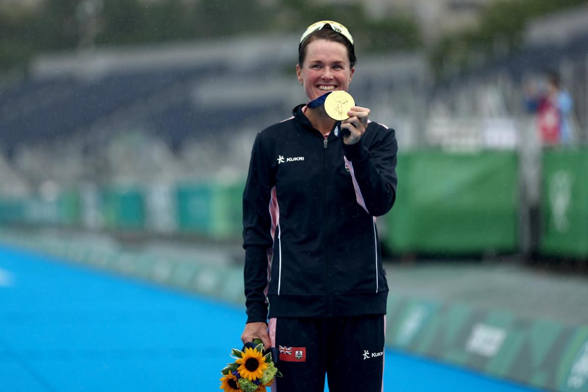 Flora Duffy, a former Buff, holds her Olympic Gold medal