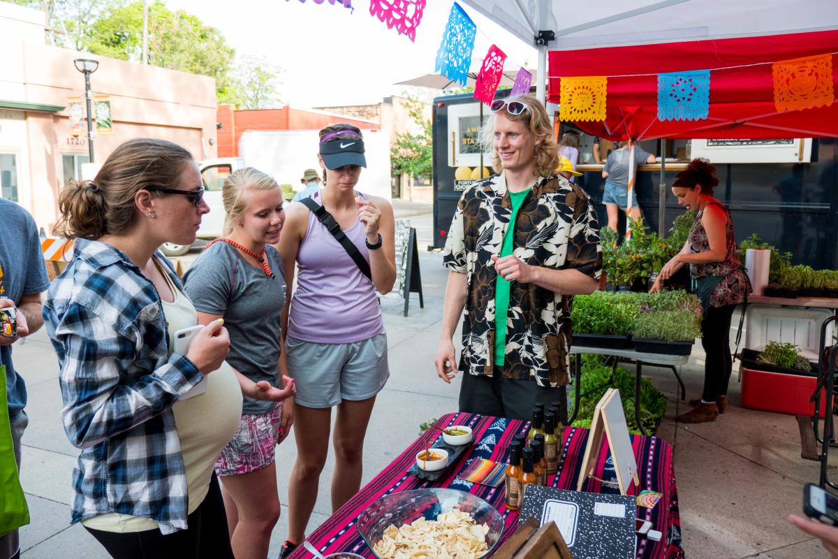 Charlie visits with customers at Boulder Farmer's Market
