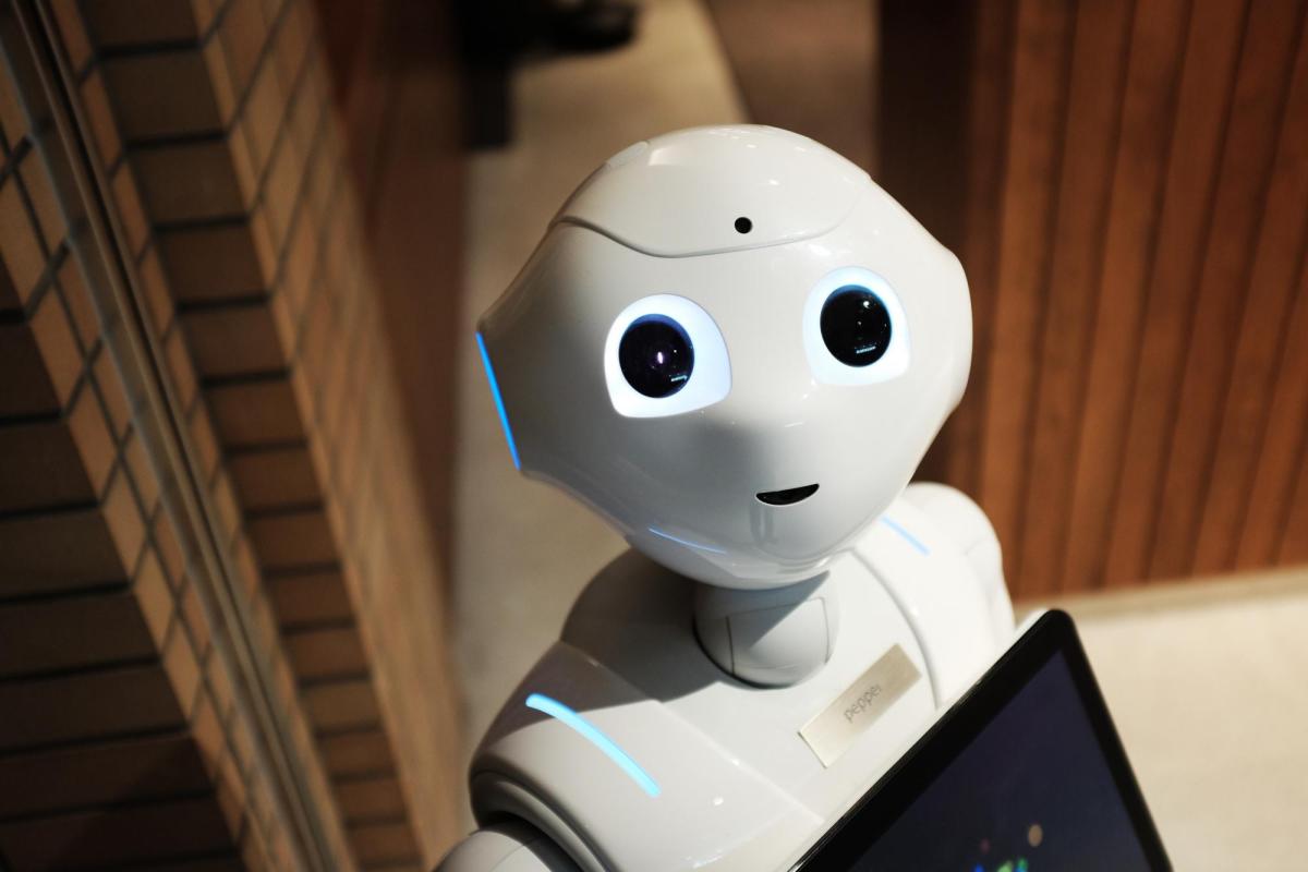 A white robot looking up.