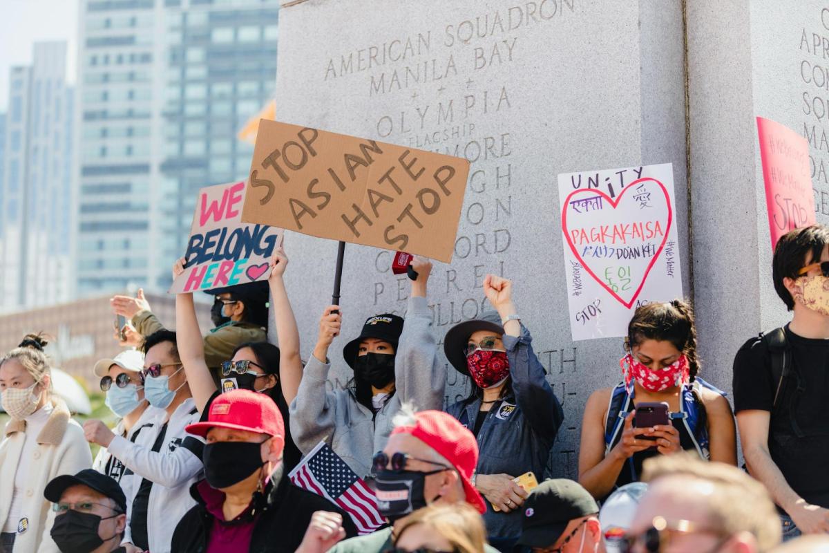People holding stop asian hate signs at a protest in San Francisco