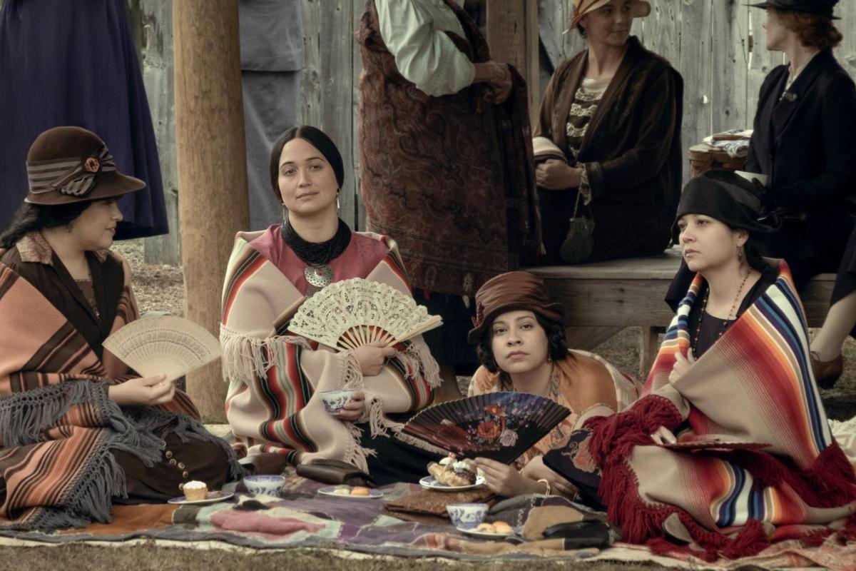 A photo showing several actors in the movie 'Killers of the Flower Moon'. The actors are portraying Indigenous women of the Osage Nation in the 1920s.