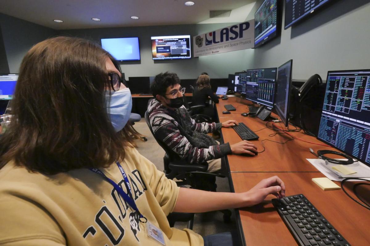 CU Boulder undergraduate students, left to right, Adrian Bryant and Rithik Gangopadhyay work in the mission operations center for IXPE.