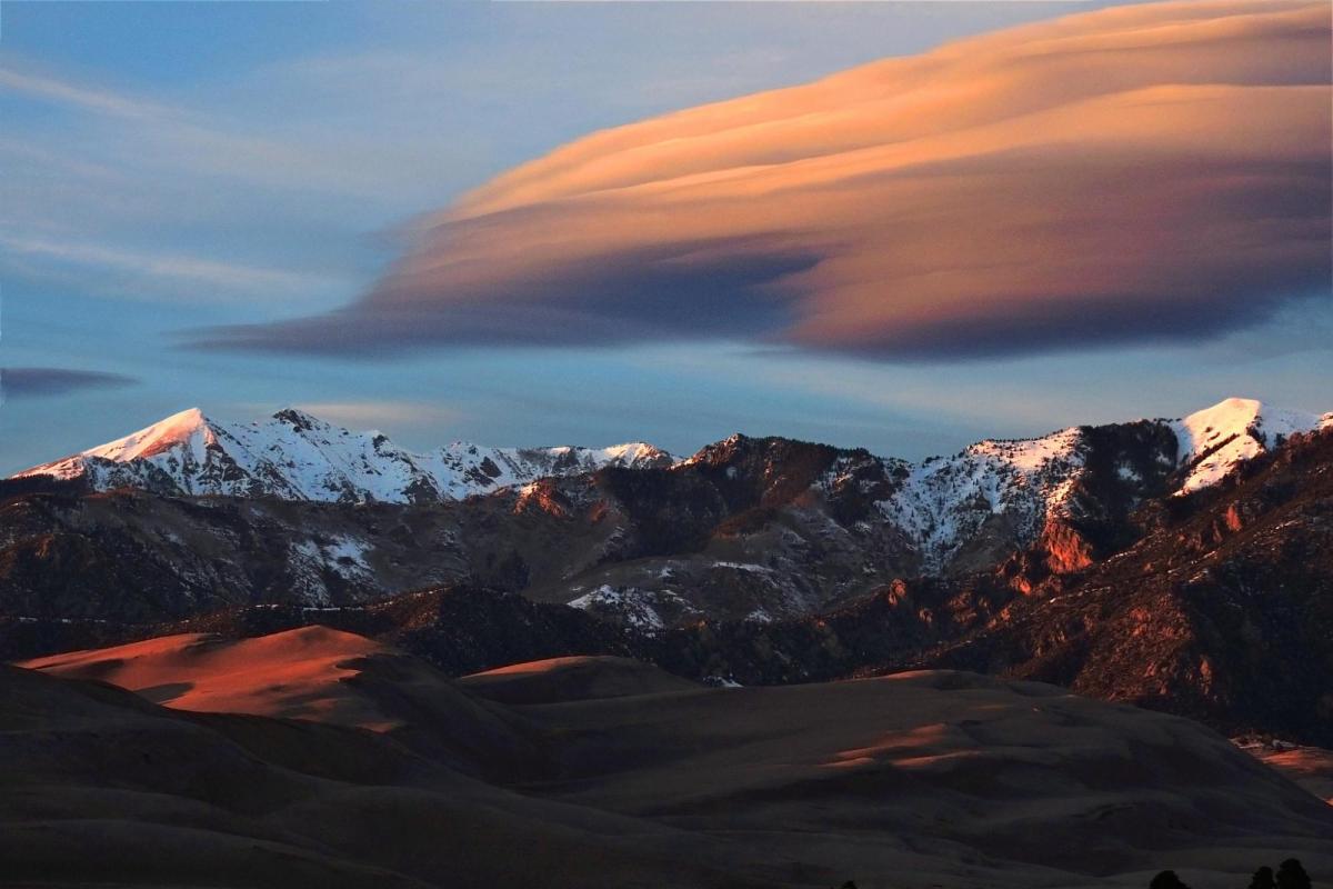 Lenticular clouds, which look a bit like a layer cake, form over Great Sand Dunes National Park in Colorado.