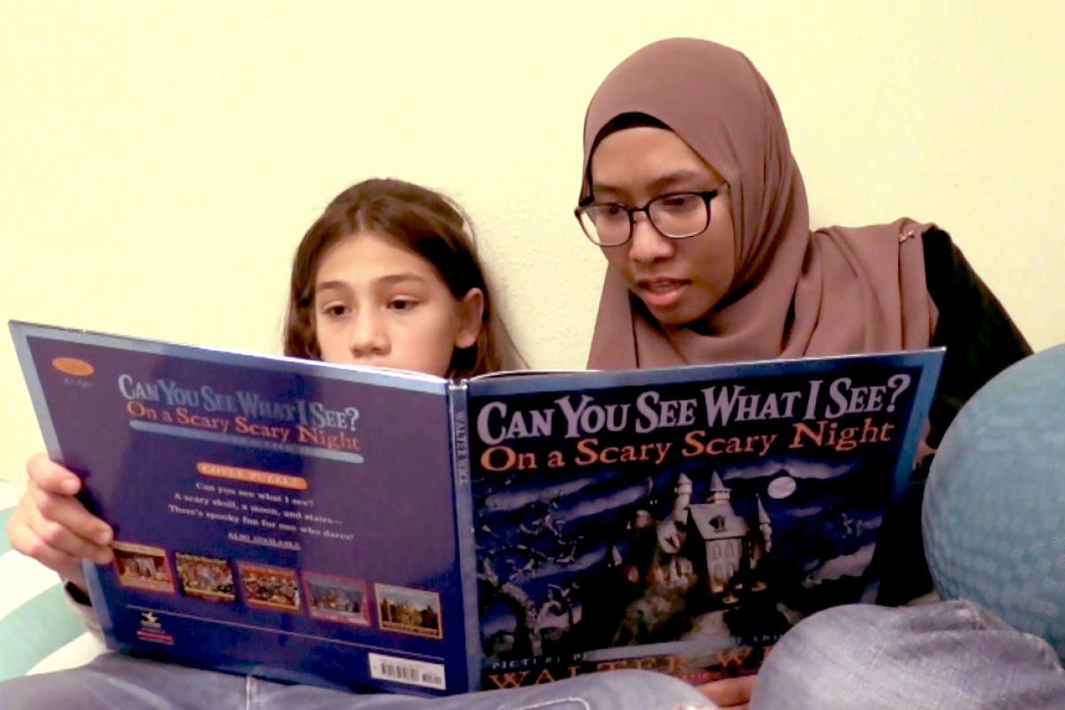 Student reads with a child