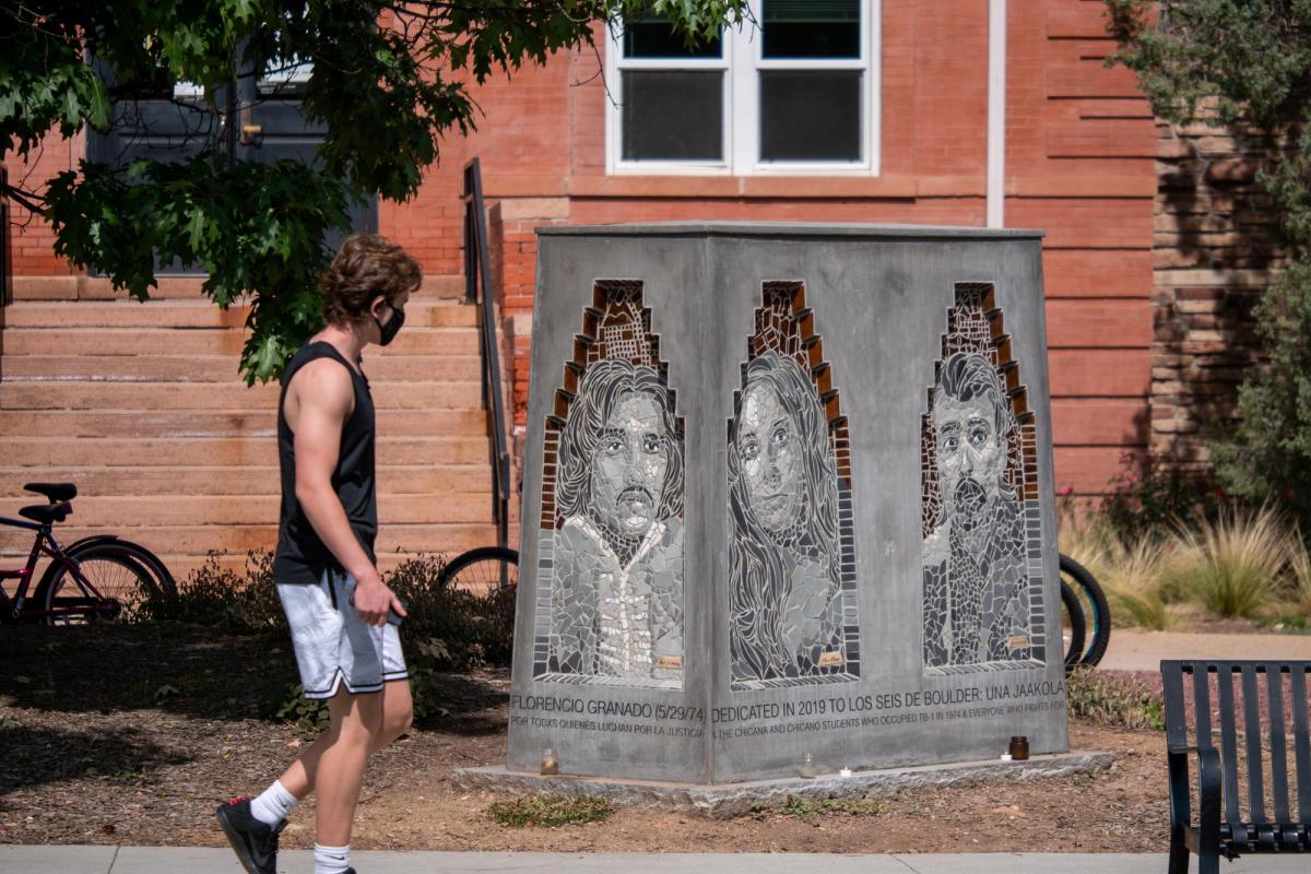 A person walks by the Los Seis de Boulder sculpture on the CU Boulder campus.