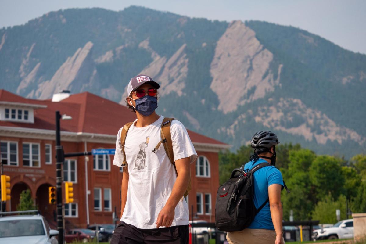 student wearing mask on campus outside