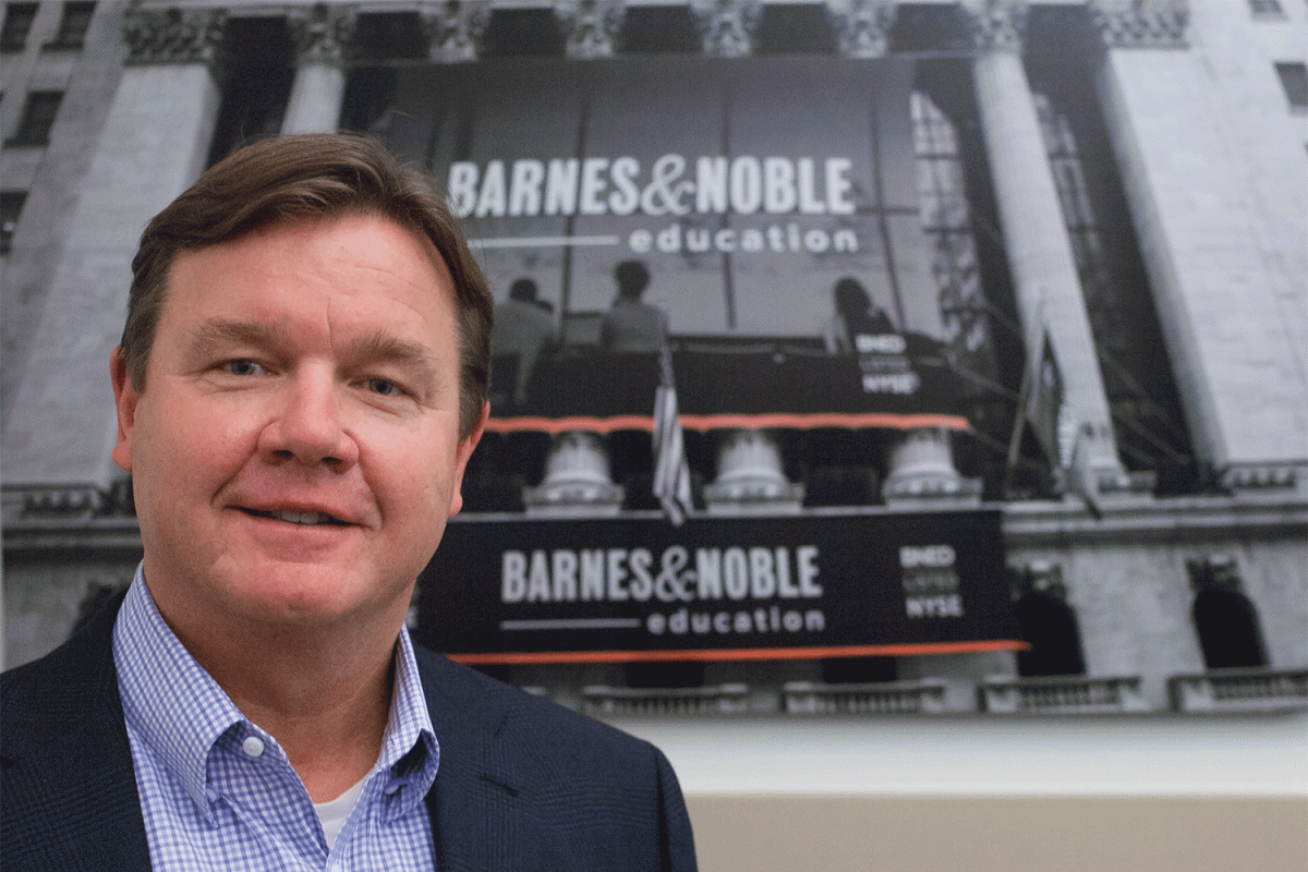 Michael Huseby stands in front of Barnes & Noble Education storefront