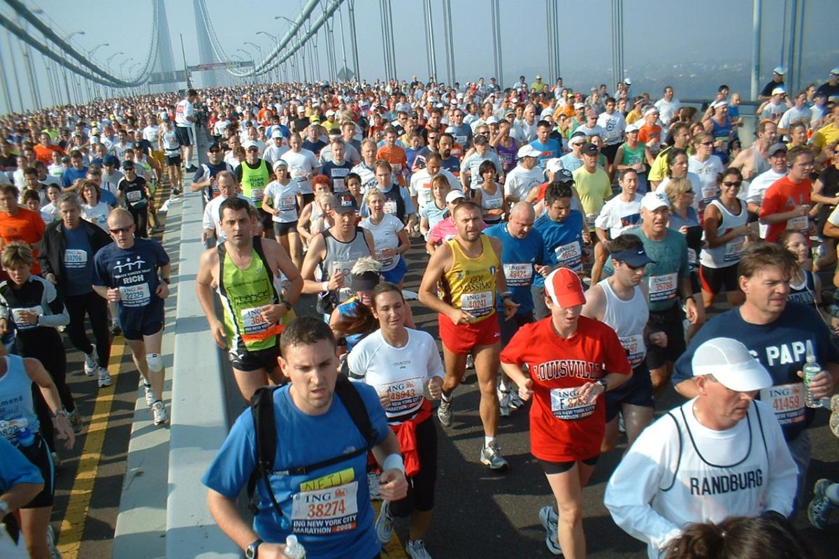 Thousands of people run across a bridge