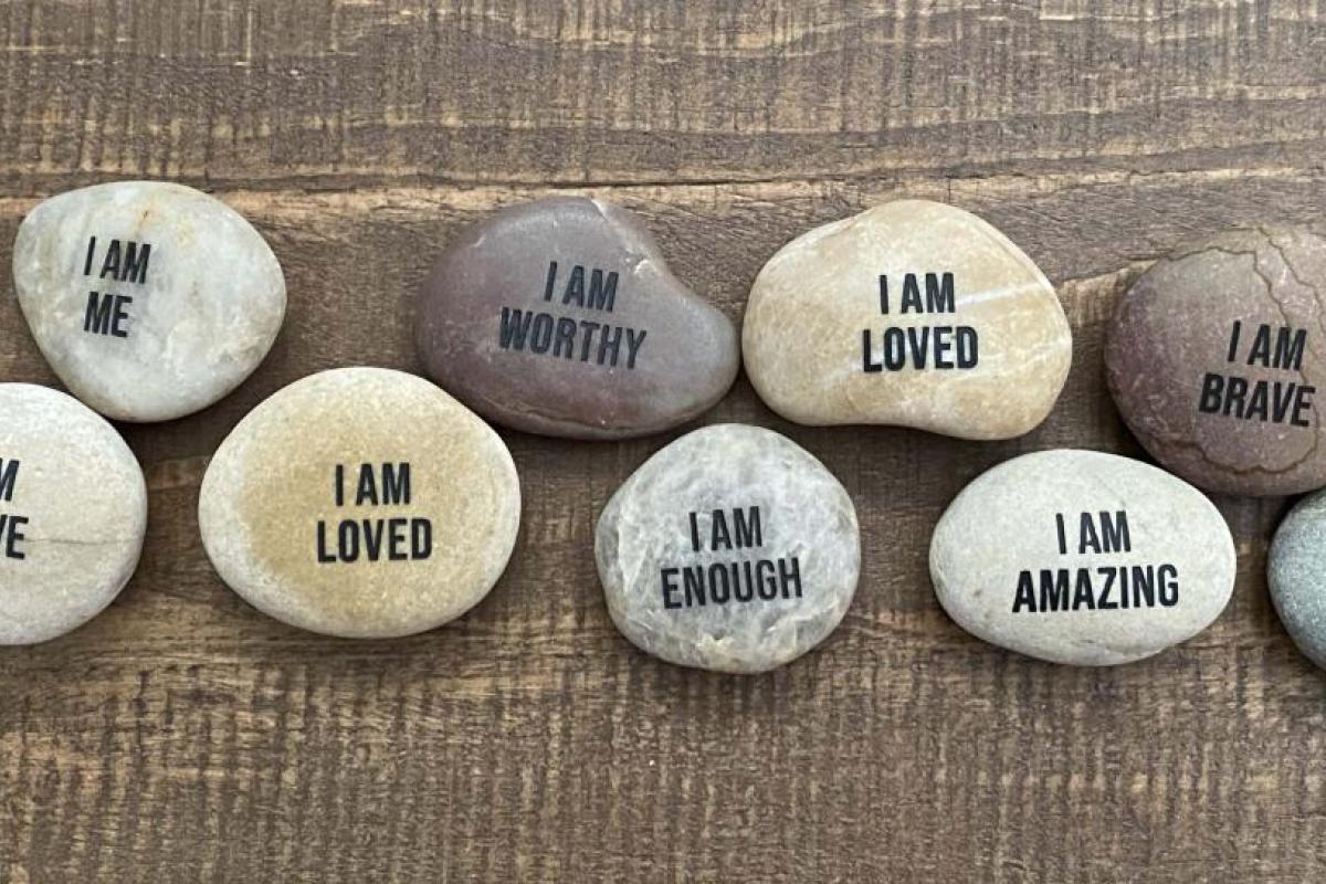 Image of rocks displaying messages of self-affirmation.
