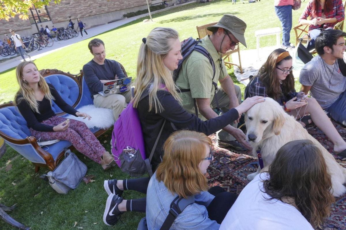 Students pet dog at the first-ever CU Boulder dog café