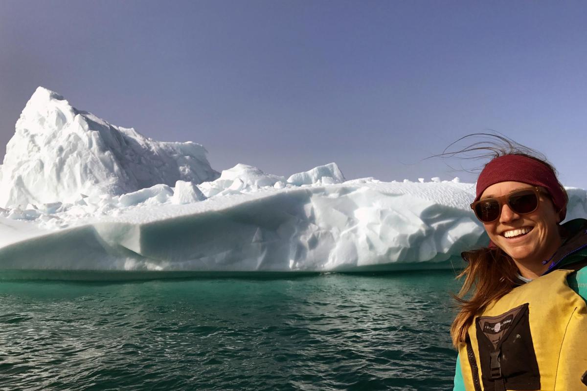 Sarah Crump poses in front of an Arctic glacier