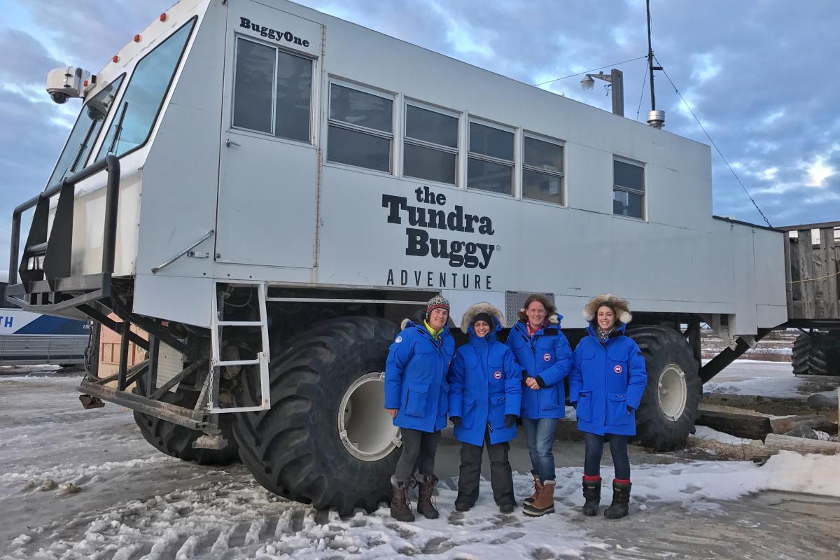 Students pose in front of the Arctic Tundra Buggy