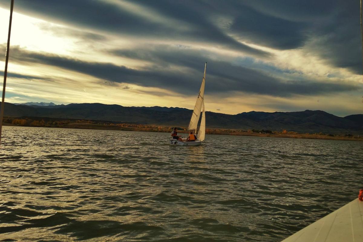 CU Boulder student sails at sunset on Colorado lake
