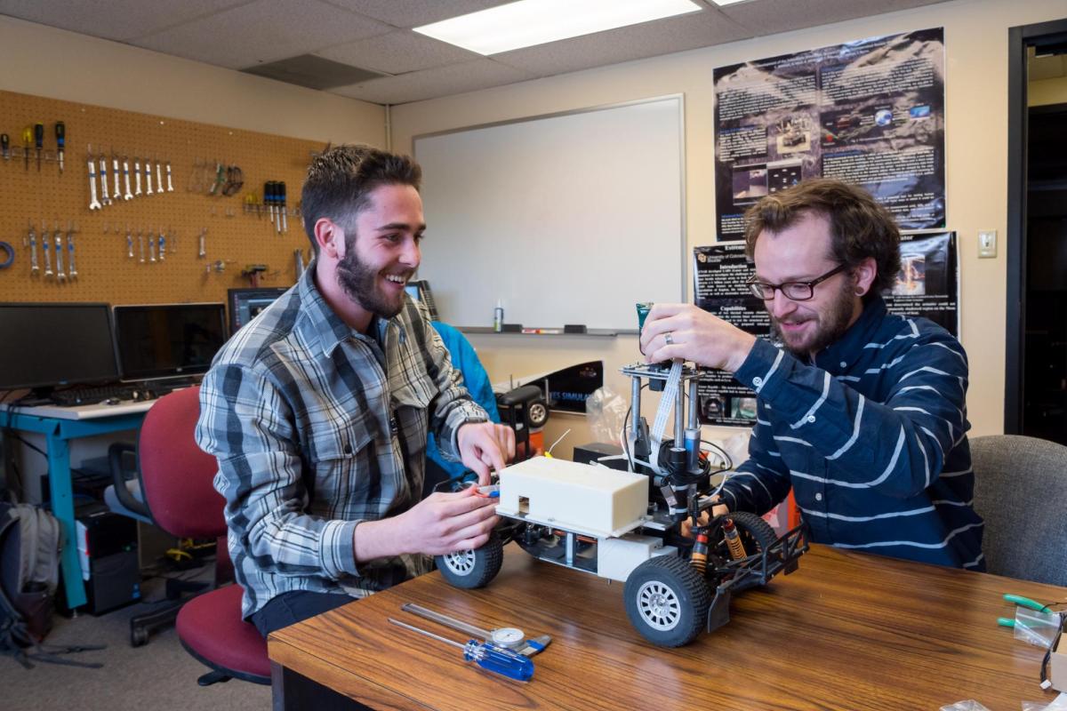 Two students with their telerobotic model