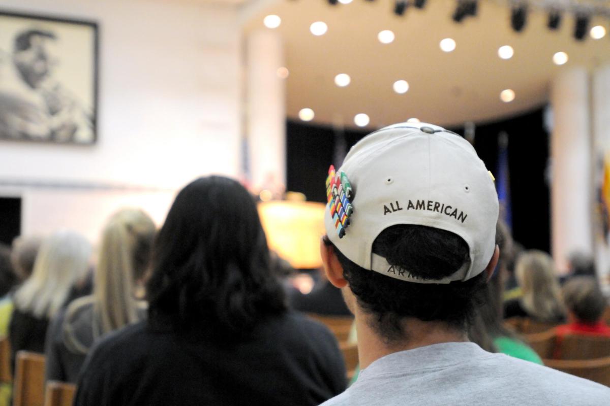 Man wearing "All American" armed forces hat