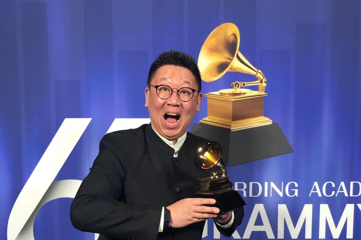 College of Music alumnus Wei Wu poses for photo with Grammy Award