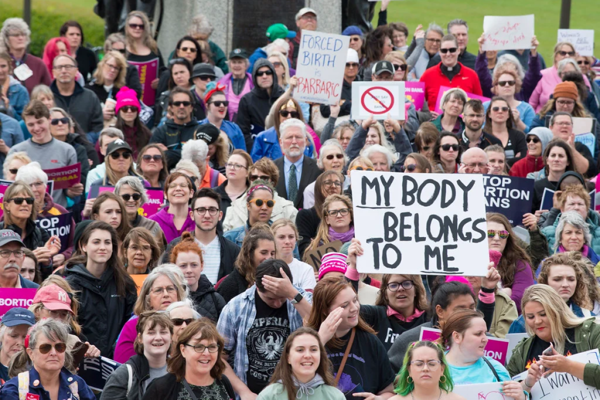 group of people marching against abortion ban