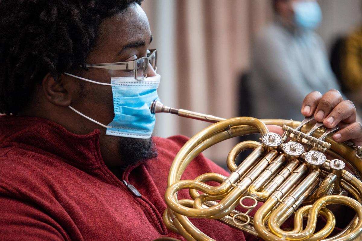 Playing French horn with a mask