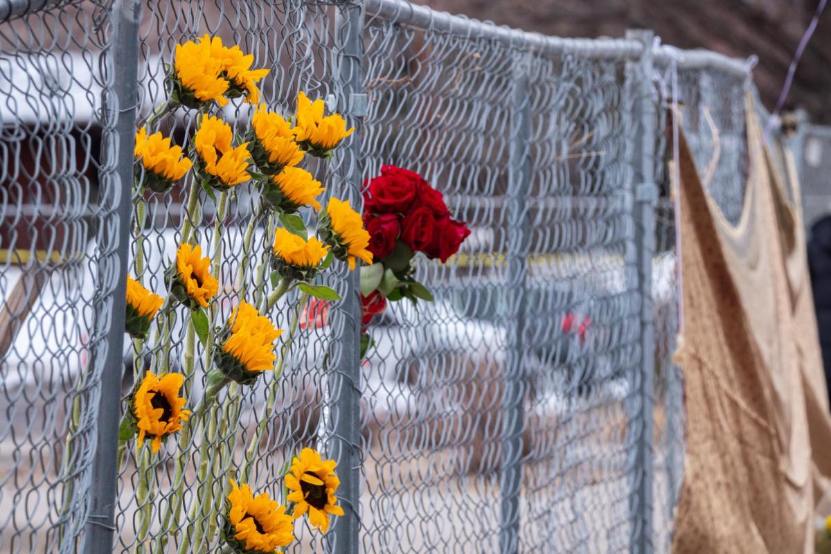 flowers line fence surrounding King Soopers parking lot in Boulder