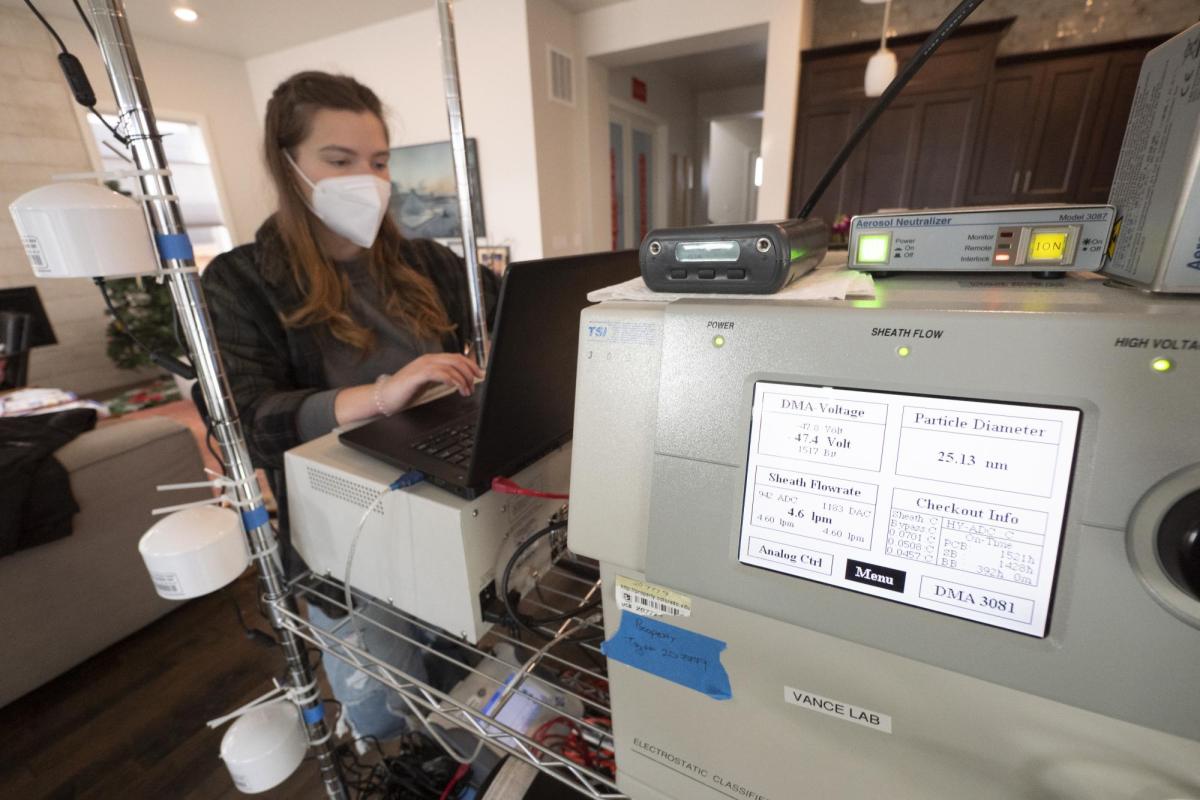 Woman works at large piece of scientific equipment