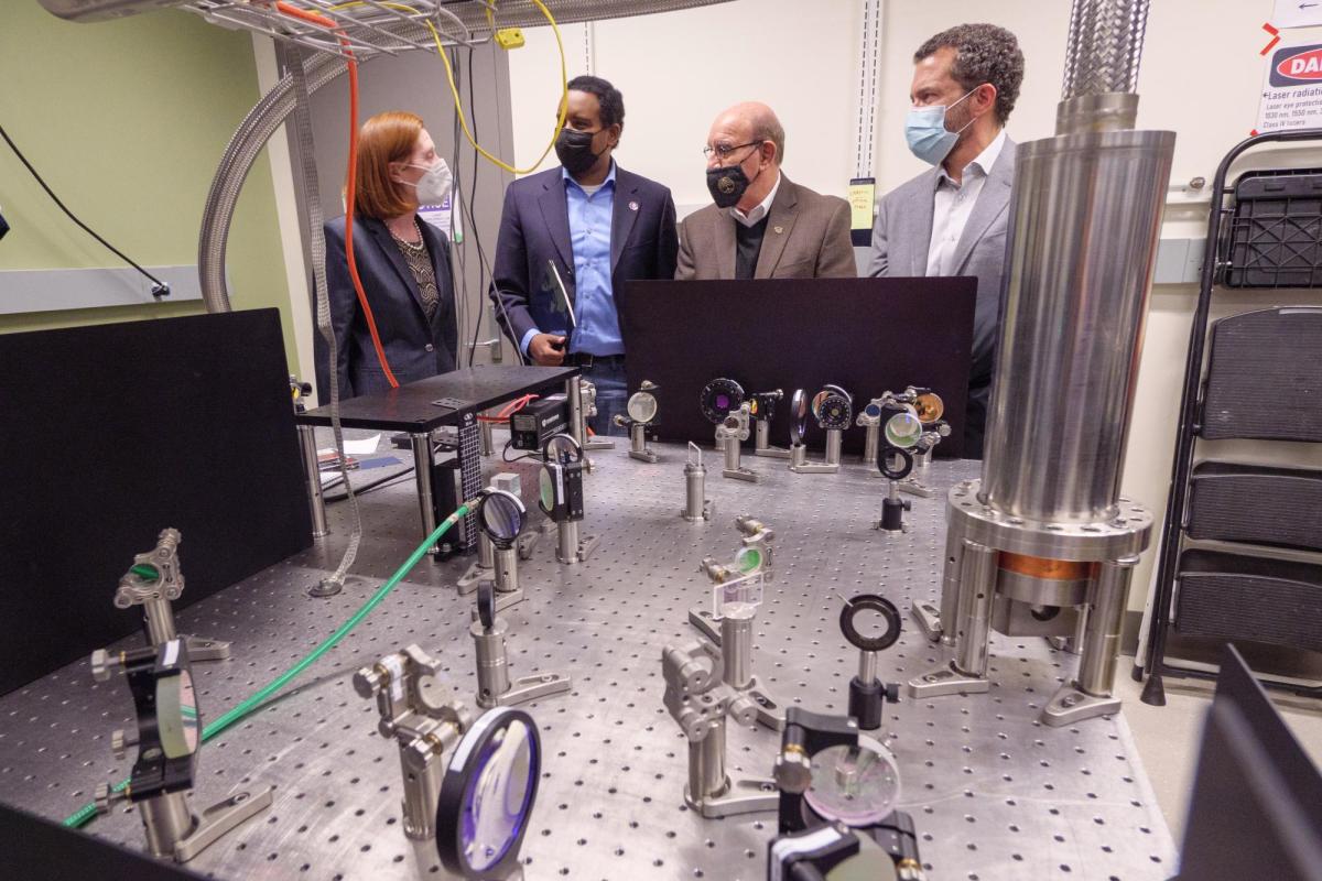 From left to right, Margaret Murnane gives tour to Joe Neguse, Philip DiStefano and Todd Saliman